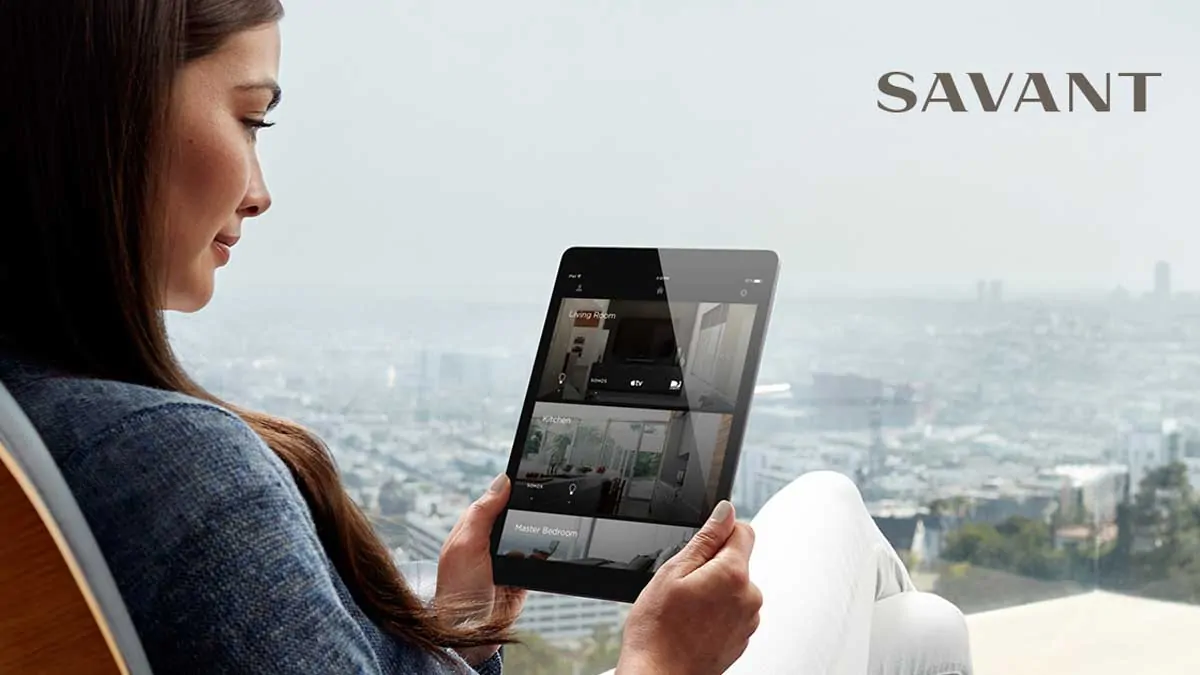 lady holding tablet with savant system